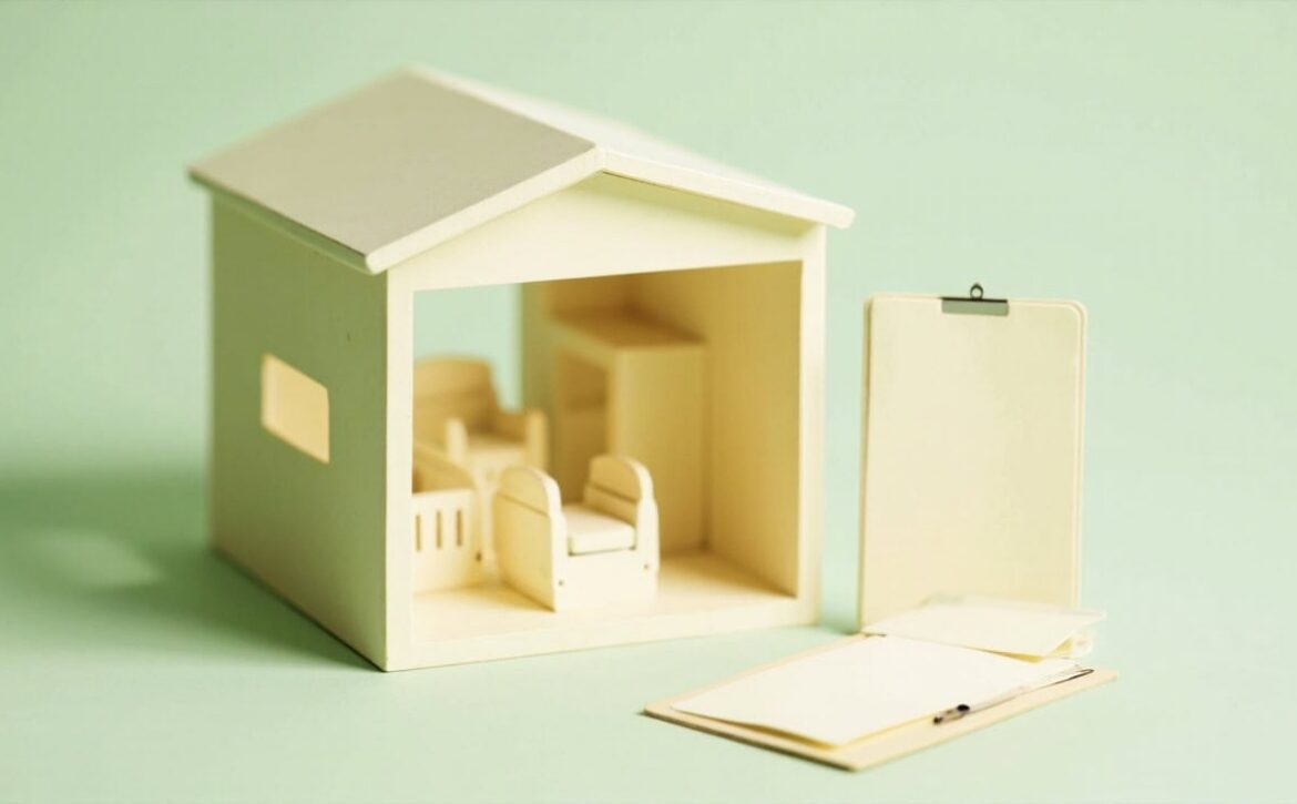 A minimalist model care room with small chairs and blank paperwork beside it in warm ivory and muted green.