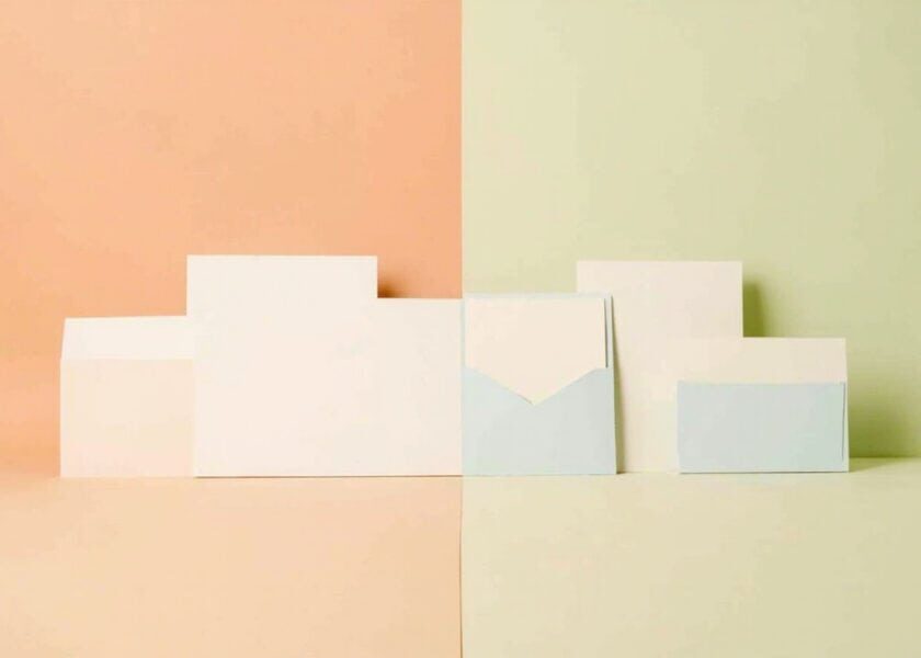 Abstract blank white and pale-blue document-like panels arranged across a peach-and-sage split backdrop.