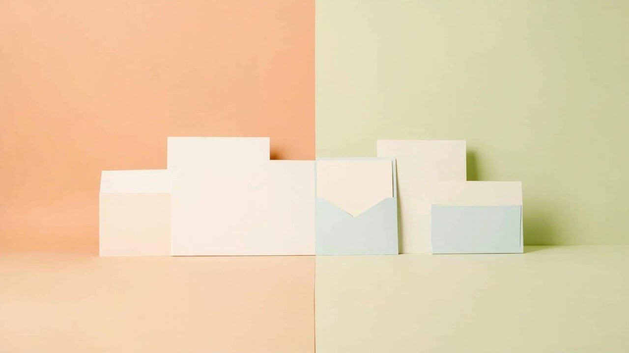 Abstract blank white and pale-blue document-like panels arranged across a peach-and-sage split backdrop.