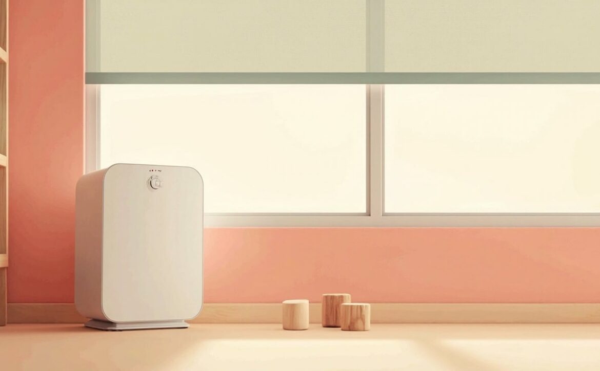 A generic white portable air purifier stands beside a closed window, with plain wooden blocks on a warm cream floor.