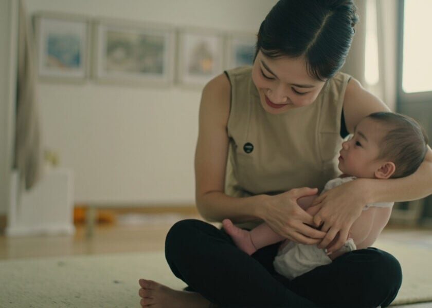 AI illustration of a childminder supporting an awake infant in a generic Singapore home